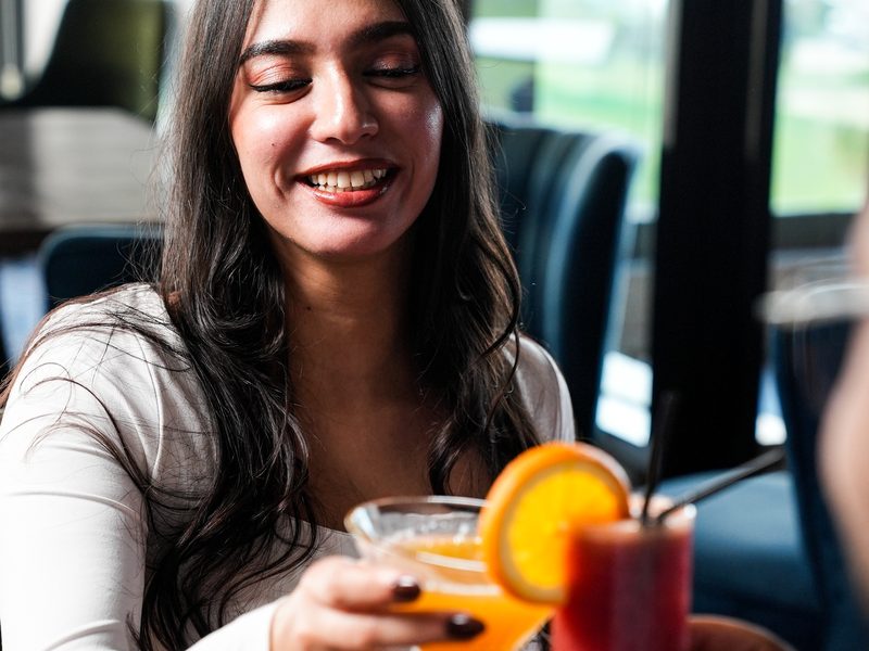 Portrait photography in Morocco — Smiling woman with a cocktail