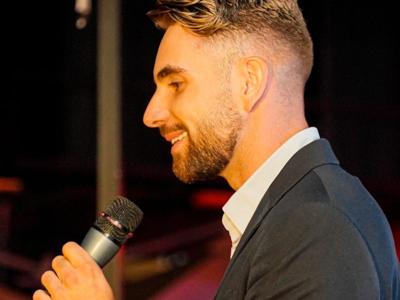 Corporate video in Morocco — Speaker with a microphone at an evening event